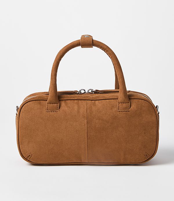 A brown suede duffel bag with a white background.