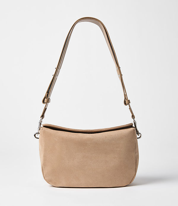 A tan suede shoulder bag with a single strap hangs against a plain white background.