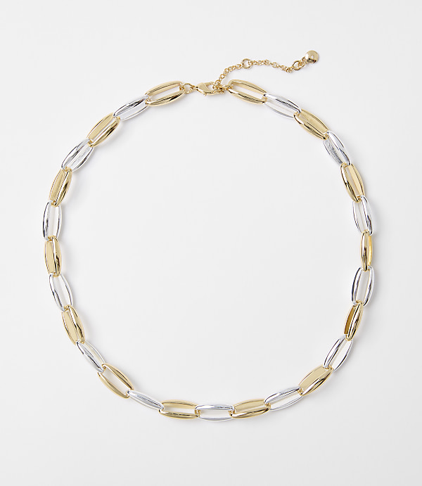 A two-toned gold and silver oval link necklace lies on a plain white background.