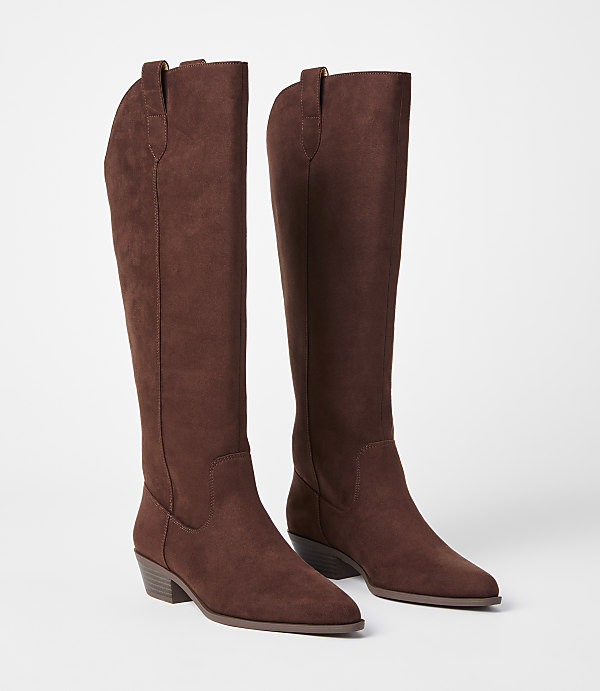 A pair of brown suede knee-high boots with pointed toes and low heels stand on a plain white background.