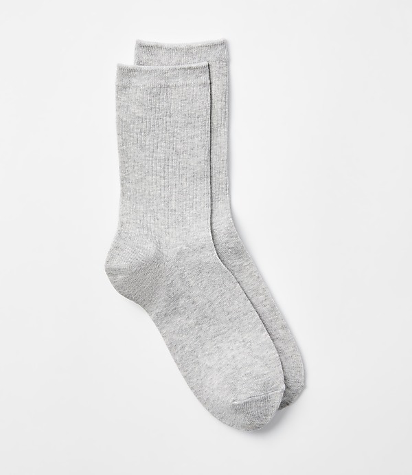 A pair of light gray ribbed socks lies on a plain white background.