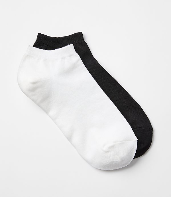 A white and black ankle sock lie side-by-side on a plain white background.