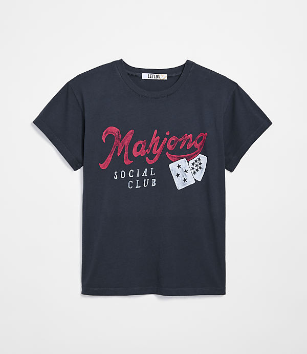 A dark navy t-shirt with "Mahjong Social Club" printed in red and white, along with two playing cards, is displayed against a plain white background.