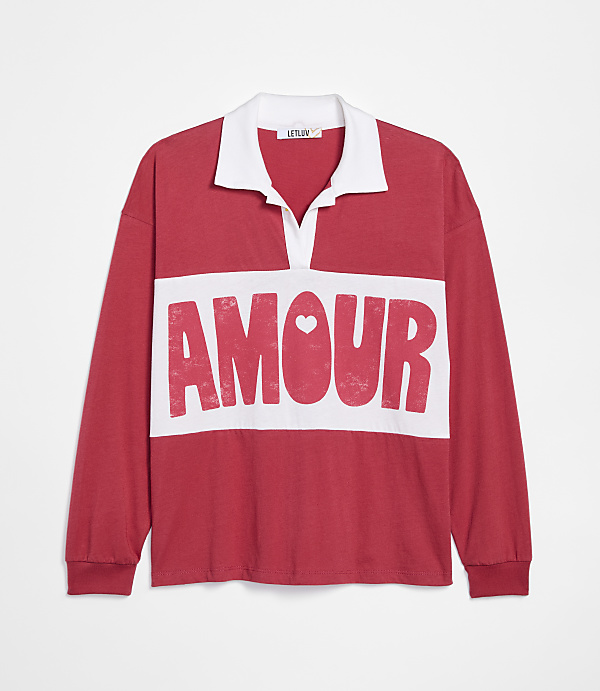 A red long-sleeved polo shirt with "AMOUR" printed in white across the chest is displayed against a plain white background.