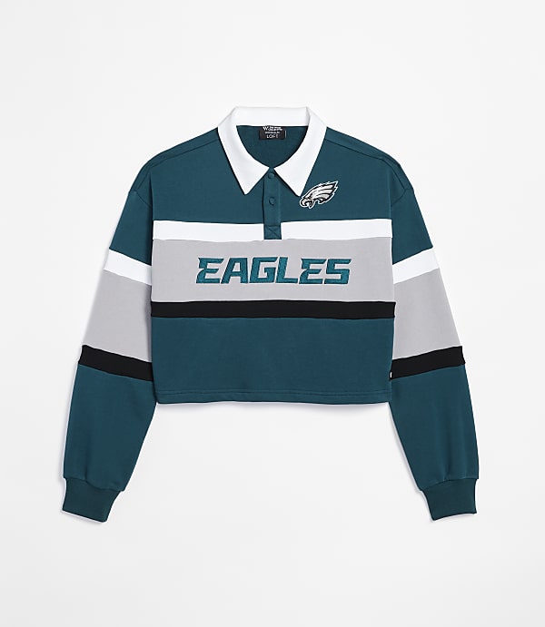 A cropped teal and grey long-sleeved polo shirt with "EAGLES" emblazoned across the chest and the Philadelphia Eagles logo on the collar is displayed against a plain white background.