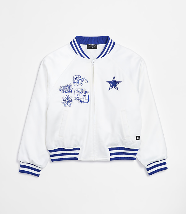 A white bomber jacket with blue trim and embroidered patches is displayed against a plain white background.