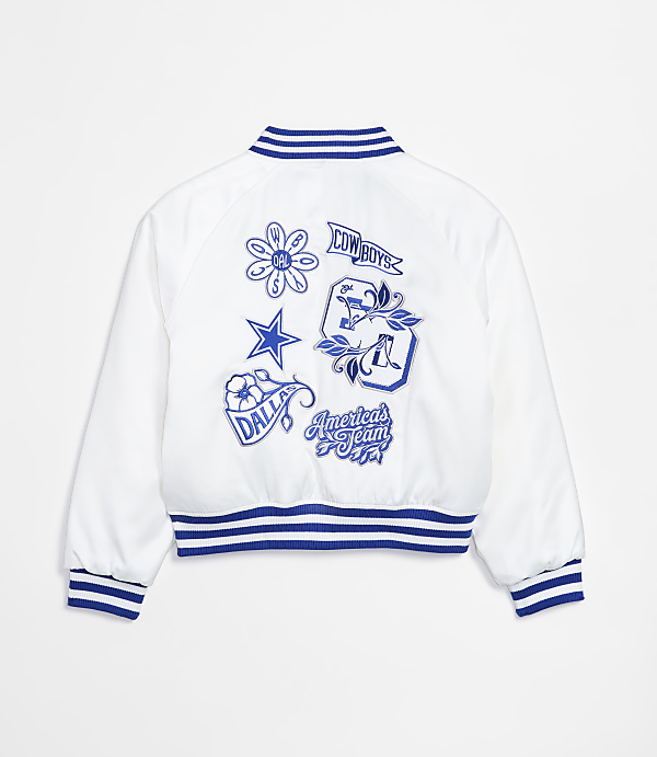 A white bomber jacket with blue trim and embroidered Dallas Cowboys patches is displayed against a plain white background.