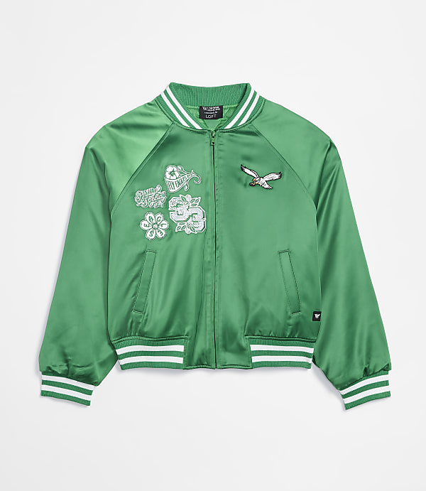 A green satin bomber jacket with embroidered patches of a bird and flowers is displayed against a plain white background.