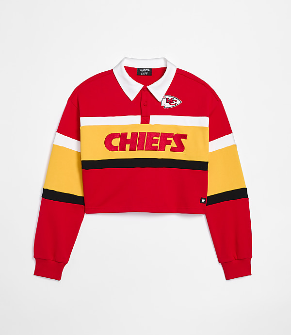 A red, yellow, and white cropped Kansas City Chiefs rugby shirt with a white collar is displayed against a plain white background.