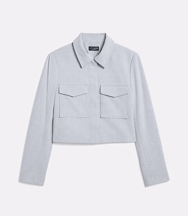A light blue cropped jacket with two chest pockets is displayed against a plain white background.