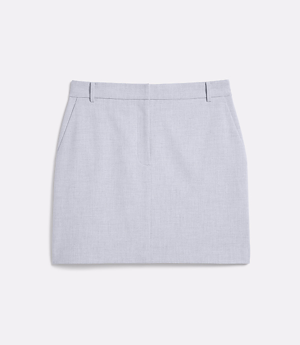 A light blue, textured mini skirt with pockets lies flat against a plain white background.