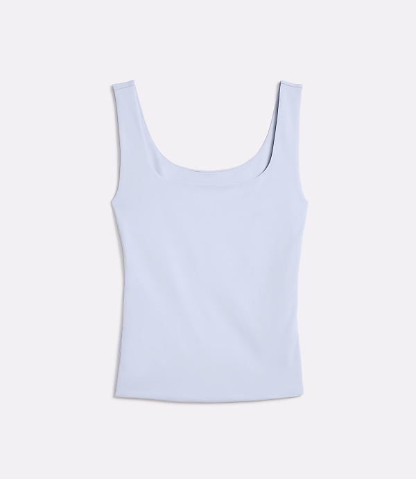 A light blue tank top lies flat against a white background.