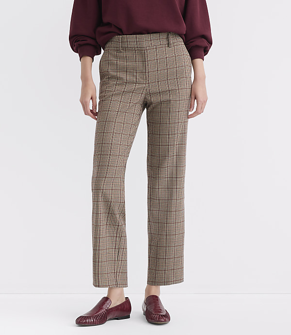 A person stands in plaid pants and burgundy loafers against a plain white background.