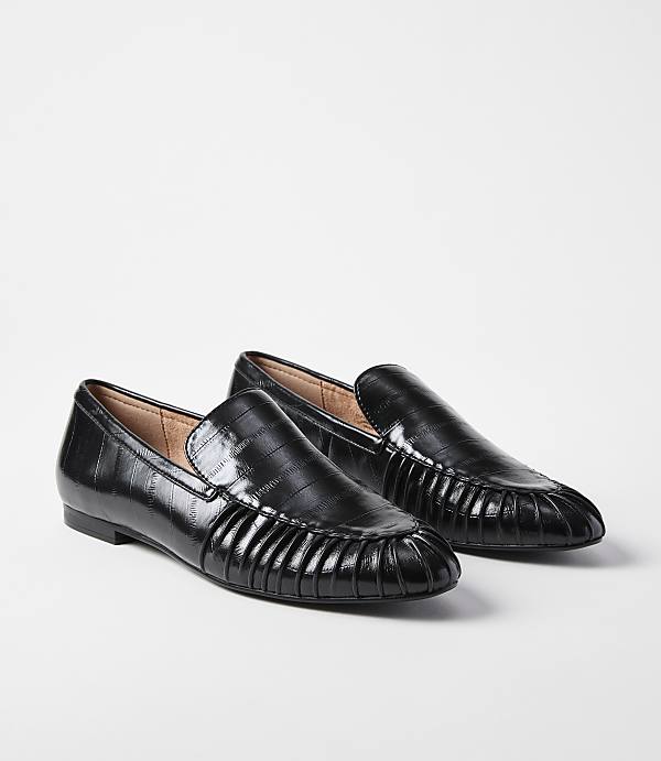 A pair of black, croc-embossed loafers with pleated detailing on the vamp rest on a plain white background.
