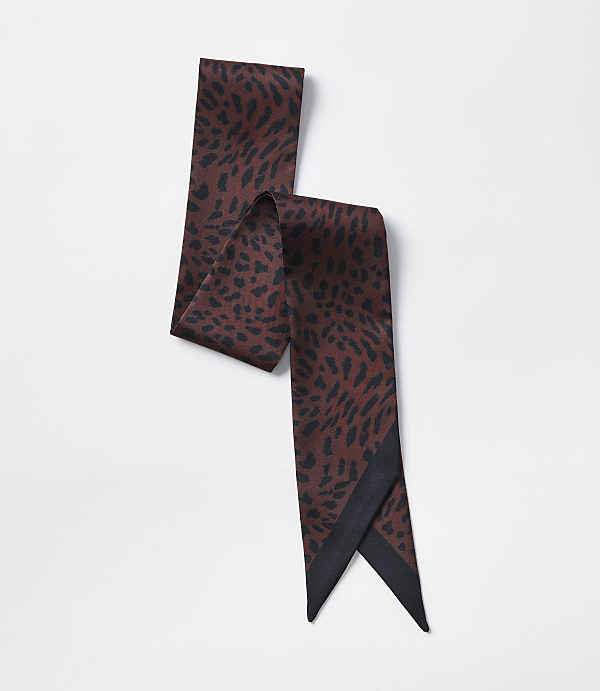 A brown leopard print scarf with a black border lies on a plain white background.