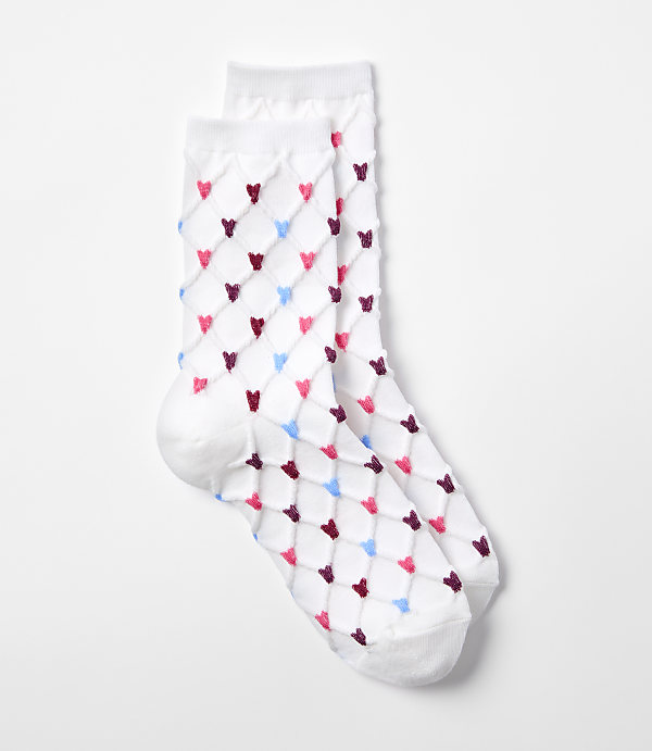A pair of white socks with a diamond pattern of pink, blue, and maroon hearts are laid out on a plain white background.