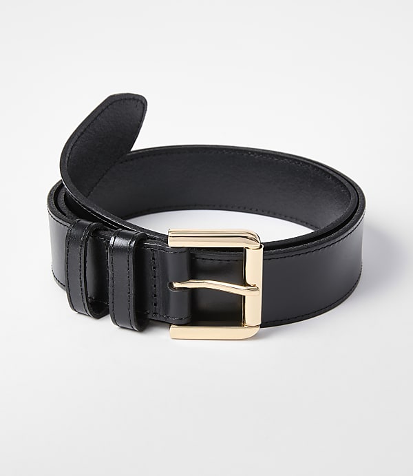A black leather belt with a gold buckle rests on a white background.