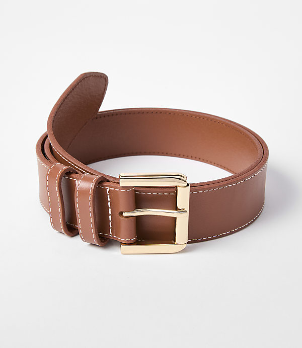 A brown leather belt with white stitching and a gold buckle lies on a white background.
