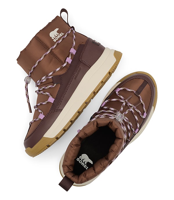 A pair of brown Sorel boots with purple accents are laid out on a white background.