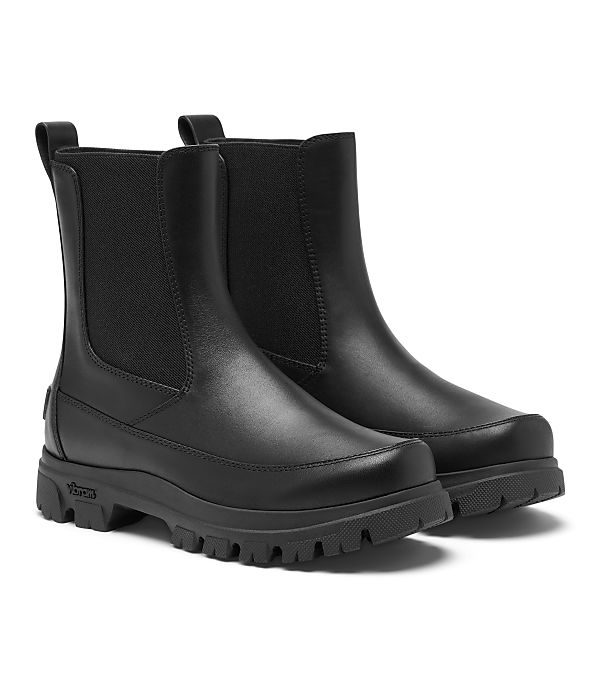 A pair of black leather Chelsea boots with thick soles are displayed against a plain white background.