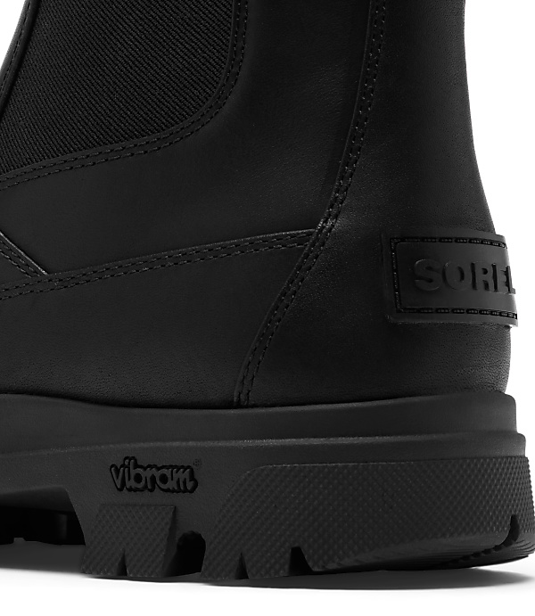 A black leather Sorel boot with a Vibram sole is shown against a white background.