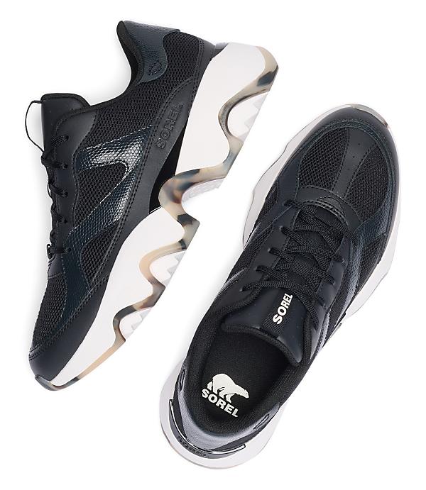 A pair of black Sorel sneakers with white soles and a marbled accent on the heel are displayed against a plain white background.