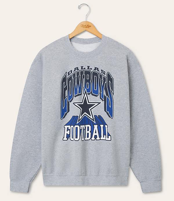 A gray Dallas Cowboys football sweatshirt hangs on a hanger against a plain, light-colored background.