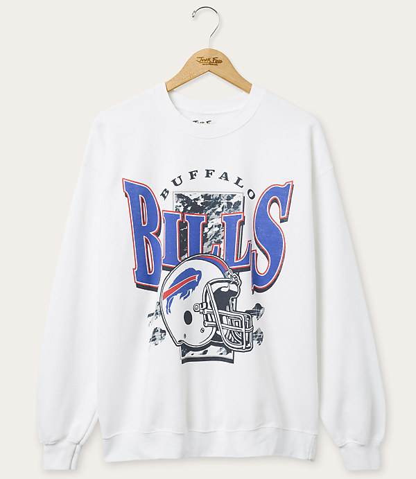 A white Buffalo Bills sweatshirt with a graphic of a helmet and team name hangs on a wooden hanger against a plain background.