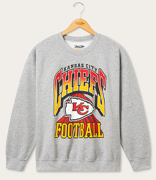 A gray Kansas City Chiefs football sweatshirt with a vintage design hangs on a wooden hanger against a plain white background.