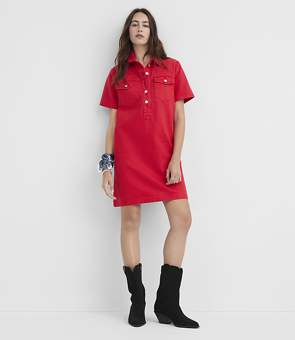 A woman in a red denim dress and black boots stands against a plain white background.