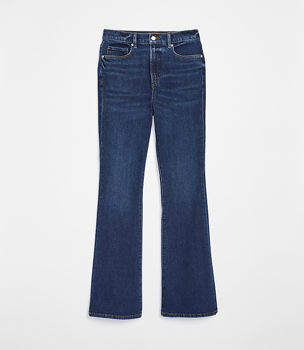 A pair of dark wash flared jeans lies flat against a plain white background.