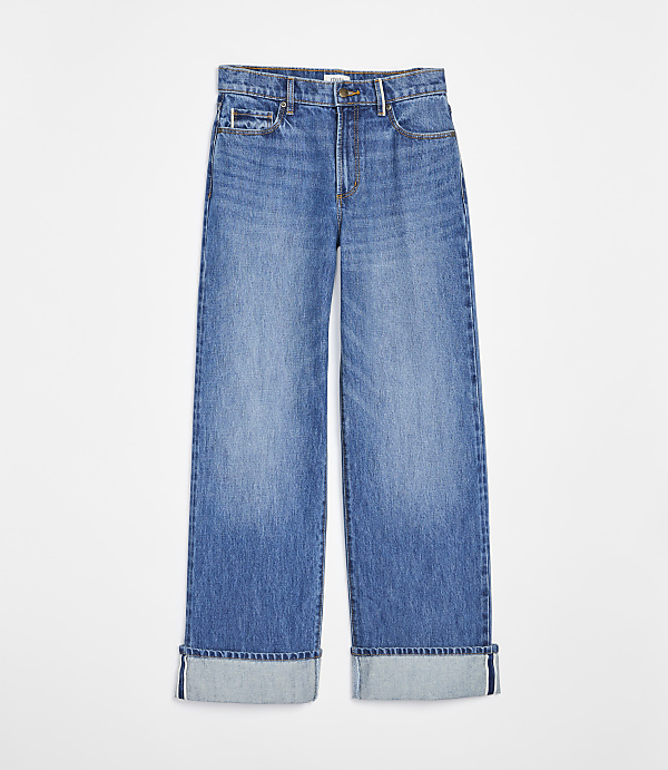A pair of cuffed, light blue denim jeans with a white background.