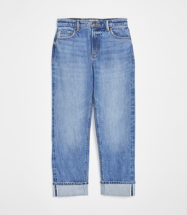 A pair of cuffed light-wash denim jeans are displayed against a plain white background.