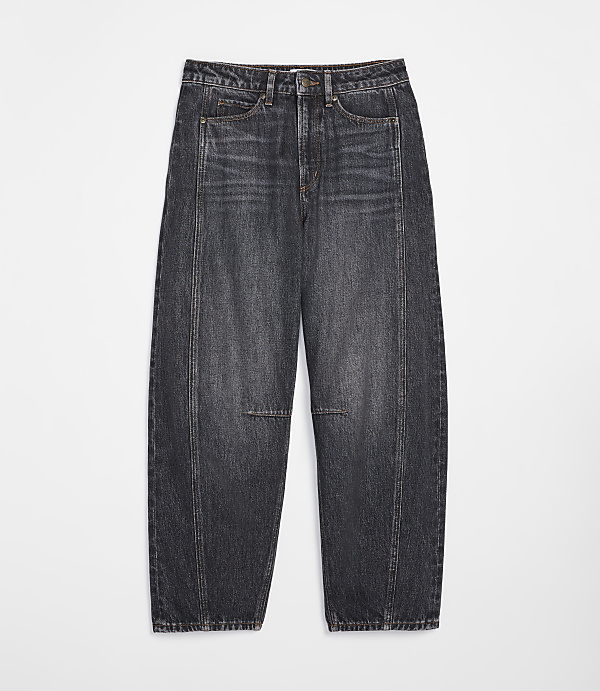 Dark wash, baggy jeans with a distressed knee are laid flat against a plain white background.