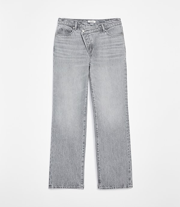 Light gray denim jeans with a unique crossover waistband are displayed against a plain white background.