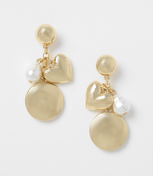 Gold-toned earrings with heart, pearl, and disc charms dangle against a plain white background.