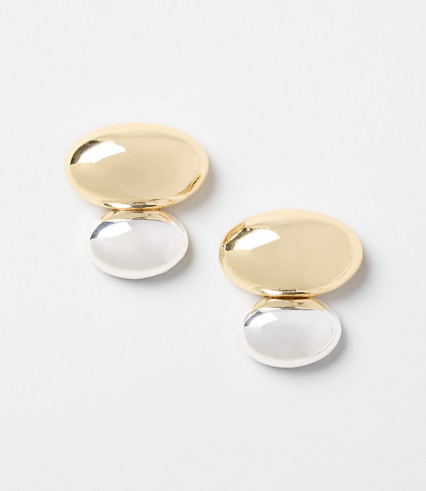 Two gold and silver oval earrings are displayed against a plain white background.