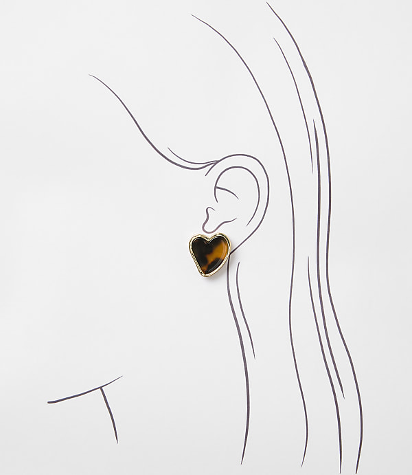 A tortoiseshell heart-shaped earring is worn on a sketched ear against a white background.