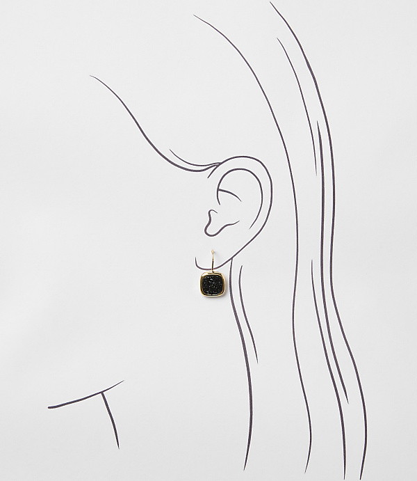 A simple sketch of a woman's ear with a square black earring hanging from it is set against a plain white background.