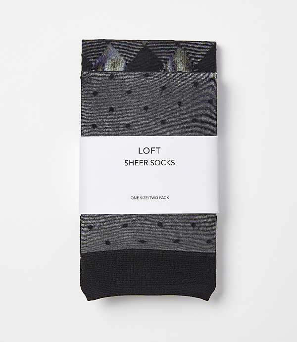 Two pairs of grey and black sheer socks with a geometric pattern and polka dots are neatly packaged with a white band that reads "LOFT SHEER SOCKS" against a plain white background.