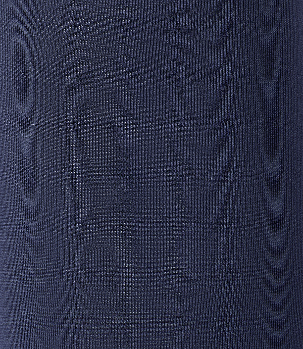 A close-up view of dark blue ribbed fabric fills the frame, with no discernible background.