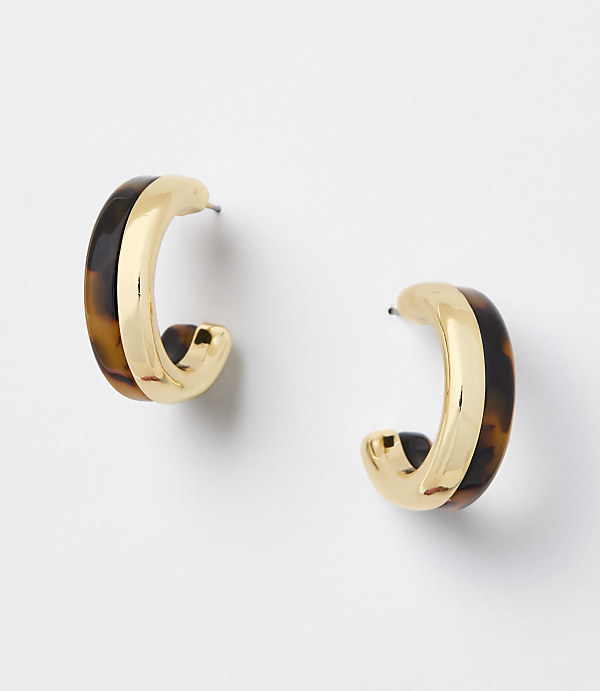 Two gold and tortoiseshell hoop earrings are displayed against a plain white background.