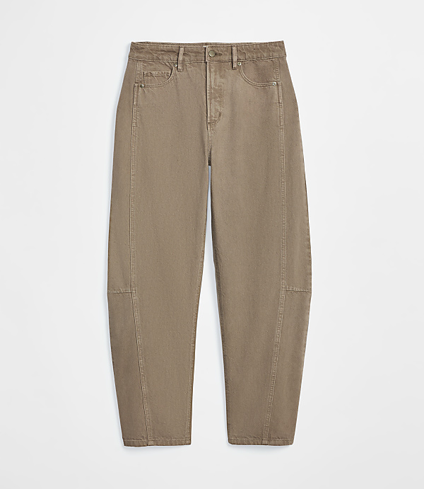 A pair of tan, balloon-shaped jeans with visible stitching is presented against a plain white background.