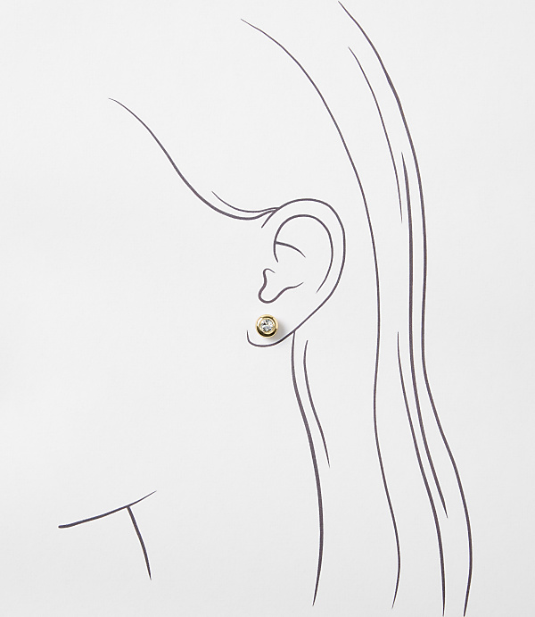 A simple gold stud earring with a clear stone is worn in a sketched ear against a plain white background.