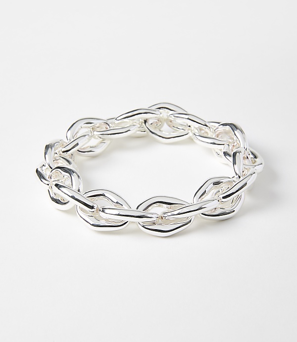 A chunky silver chain bracelet lies on a plain white background.