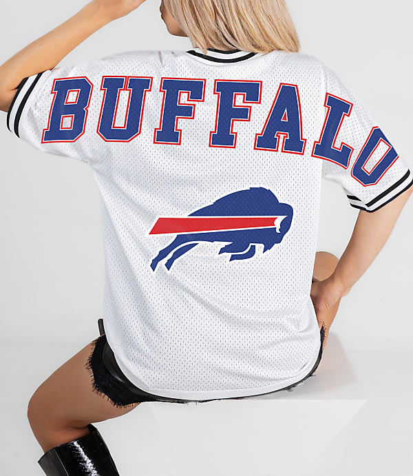 A person in a white Buffalo Bills jersey sits in front of a white background.