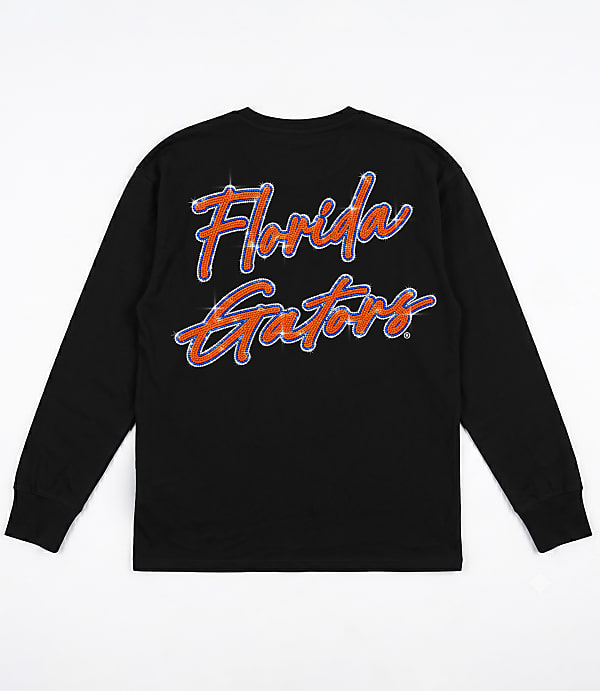 A black long-sleeved t-shirt with "Florida Gators" written in a sparkly orange and blue script is displayed against a plain white background.