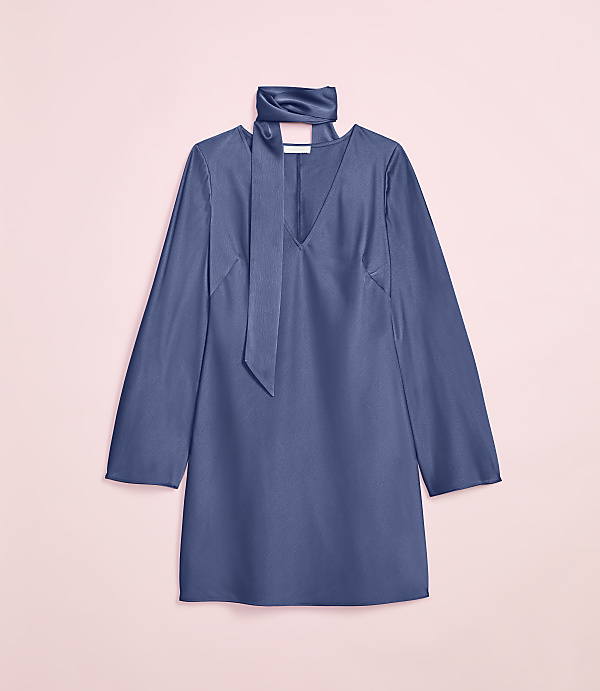 A blue satin dress with a tie neck is laid flat against a soft pink background.
