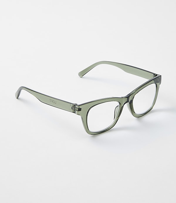 A pair of translucent green glasses rests on a plain white background.