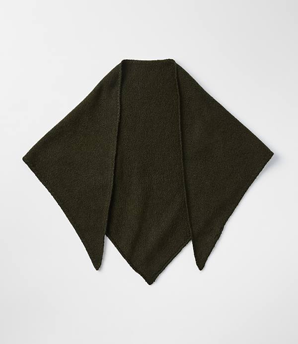 A dark green, knitted triangular shawl lies flat on a plain white background.